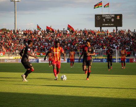 Eswatini vs Angola football match preview graphic with team logos and stadium background.
